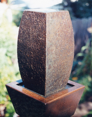 Image of a small bronze water feature.