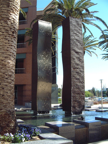 Image of a large bronze and stainless steel water feature.