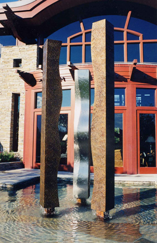 Image of a large bronze and stainless steel water feature.