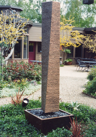 Image of a small bronze water feature.