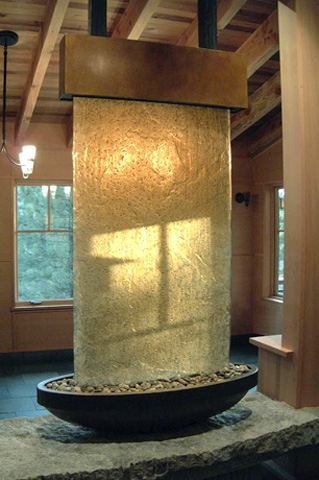 Image of a bronze and glass waterwall.